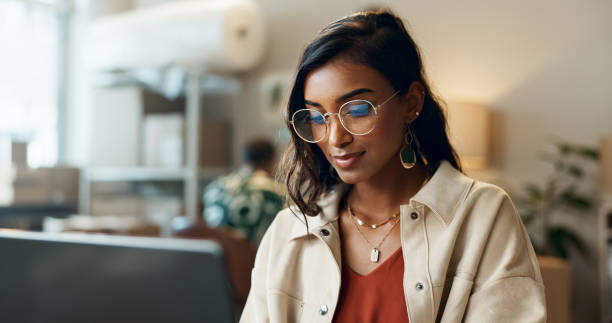 istock Ecommerce, woman and typing on laptop at work for research, feedback and supply chain for business. Indian, person and planning on pc for logistics, stock administration or package distribution 1824157738
