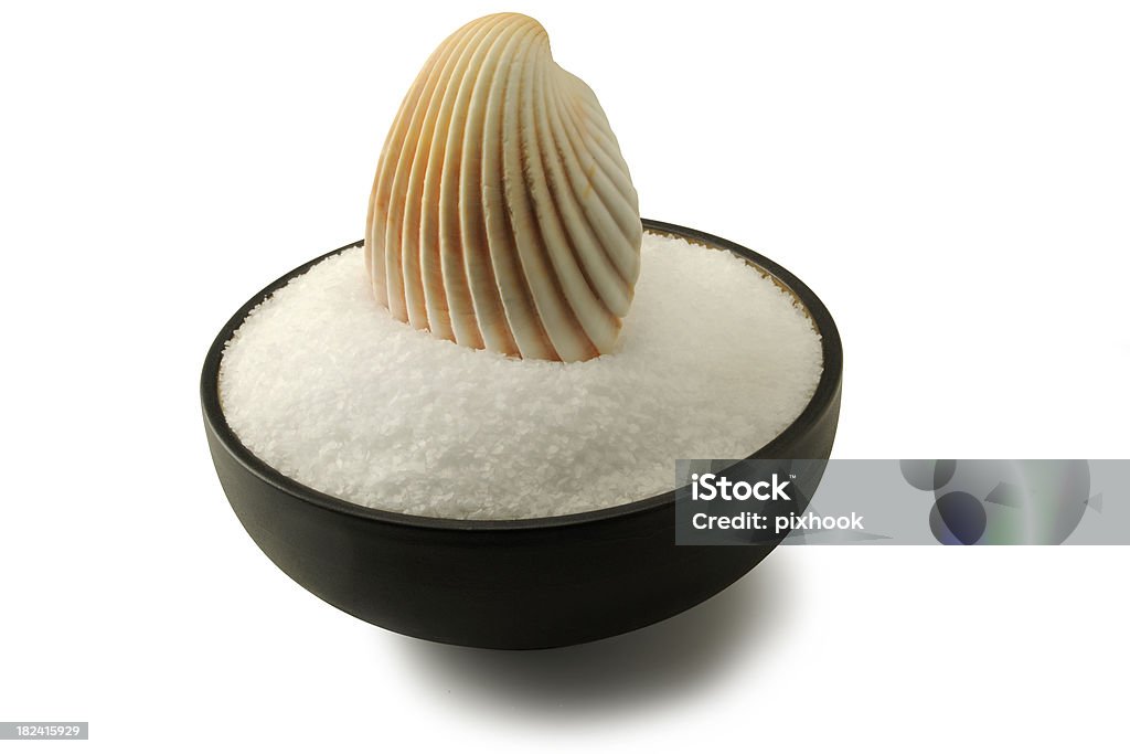 Sea Salt "Sea Salt in Bowl with Sea Shell Scoop, isolated on a white background. Clipping path included." Animal Shell Stock Photo