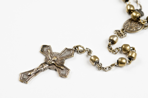 Rosary lying on the table, Catholic cross