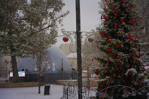 Budapest, Hungary - November 30, 2023: Snowy Christmas tree at Vorosmarty square.