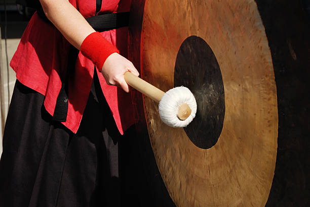 istock hand with stick and gong 182416726