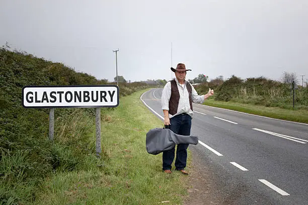 Mature man standing at roadside with guitar. Self portrait MR.