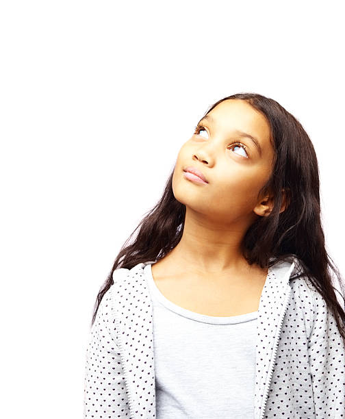 Little girl looking up at blank space over white