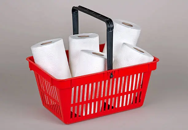 Paper towels in red shopping basket. 