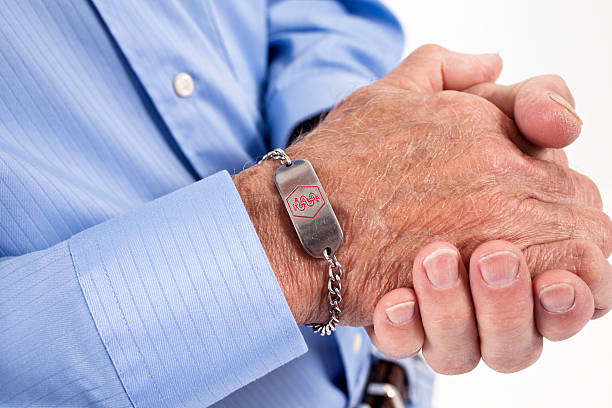 Senior man with medical alert bracelet stock photo