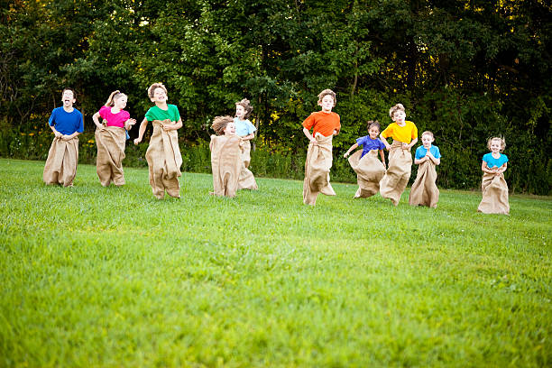 istock Happy Children Having a Fun Potato Sack Race Outside 182417436