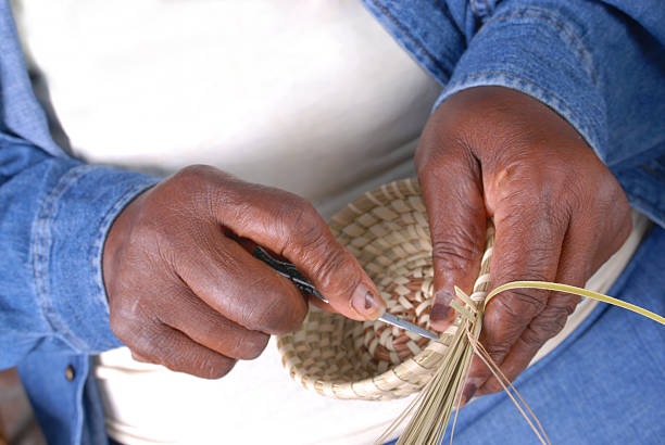 Sweetgrass Basket Weaving Basket Weaving in the south. Vanishing art form of Sweetgrass Baskets. weaving photos stock pictures, royalty-free photos & images
