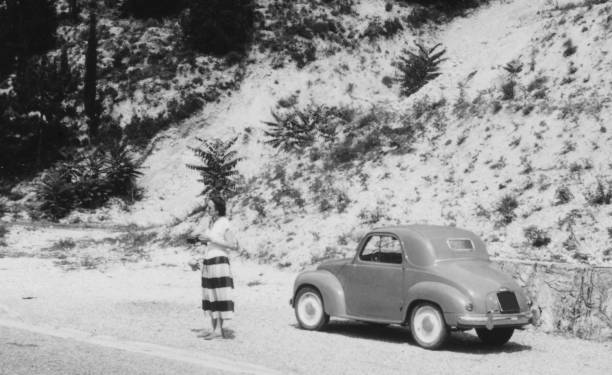 istock Young Woman and Vintage Car. 1824175250