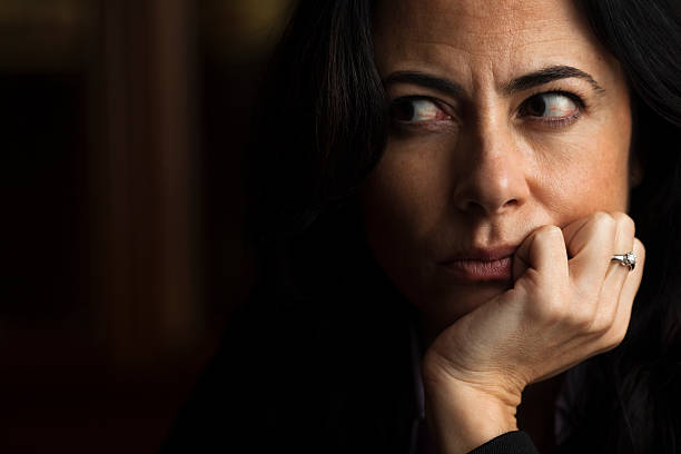 istock A woman with her hand on her chin cutting her eyes sideways 182418237