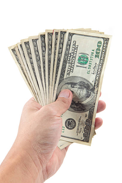 istock hand holds hundreds of dollars 182418487