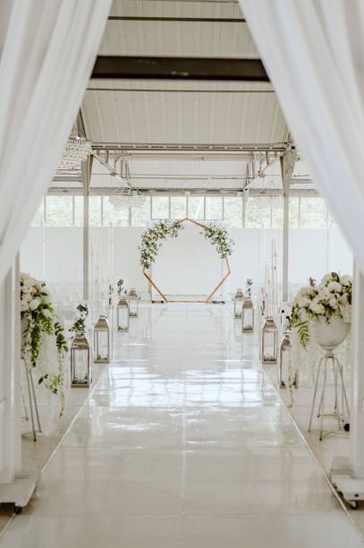 istock Elegant wedding ceremony site with white chairs and romantic lighting 1824186954