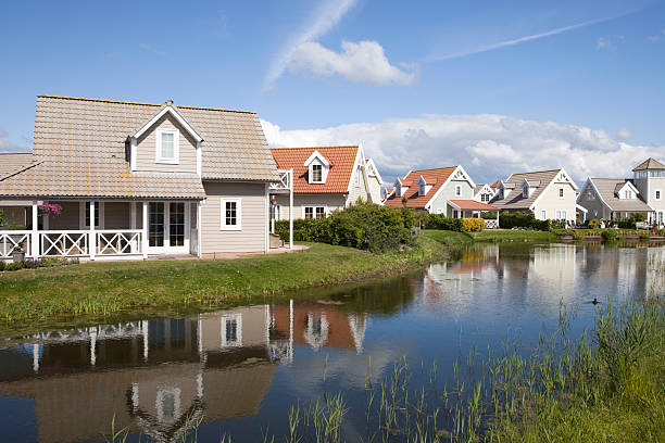 reflection of Scandinavian style holiday houses in the water stock photo