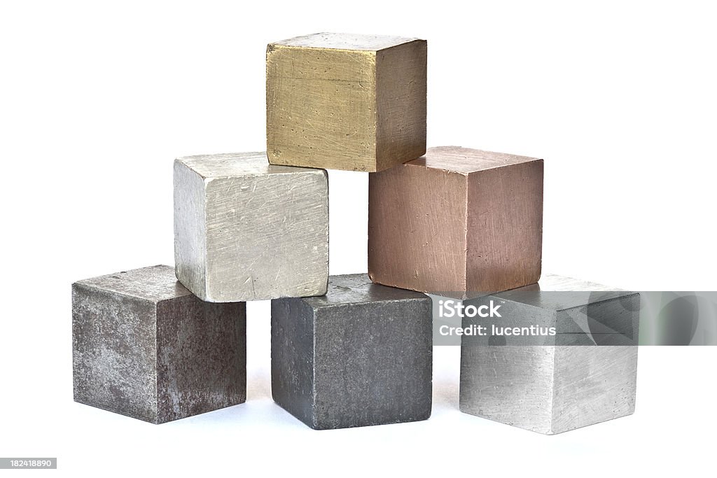 Six different metal cubes isolated on white "Six common metals imaged on white card. From left to right, bottom row iron zinc aluminum, middle row tin copper, top row brass. Shadow perspective cast by the blocks fades to a pure white background. There are companion images:" Copper Stock Photo