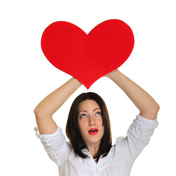 istock Beautiful confused model holding  a heart shaped card 182418952