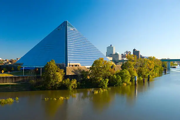 "The Pyramid Arena landmark building in Memphis, with the Memphis Downtown skyline in the background and Wolf River in the foreground."