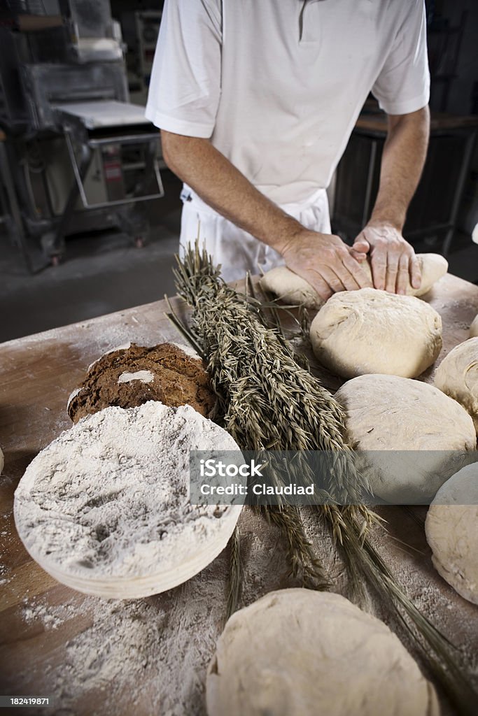 Baker Baker and his son kneading dough.More photos of the baker and the bakery: 18-19 Years Stock Photo