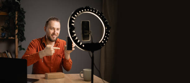 istock Influencer recording unboxing video modern smartphone for his vlog. Creative content creator. 1824209518