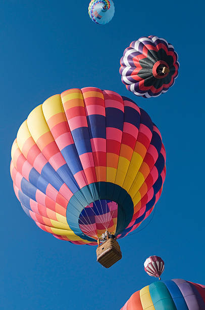 Hot Air Balloons at dusk reflecting off water and ice. 
