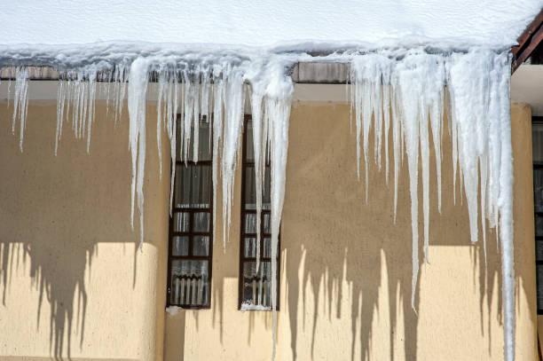 istock Pointed icicles hanging from the roof 1824213350