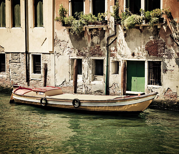 istock Boat in venetian canal 182421647