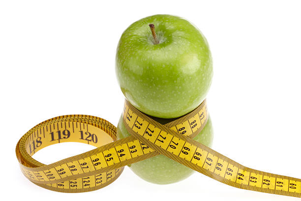istock Green apples with measure tape from above 182421890
