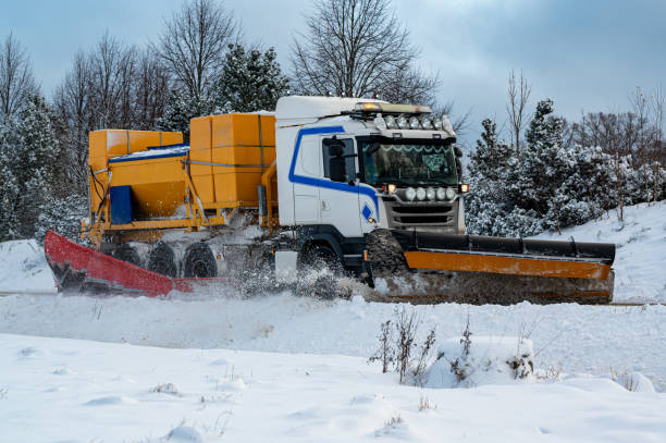 istock Truck plowing snow and putting salt on road 1824219155