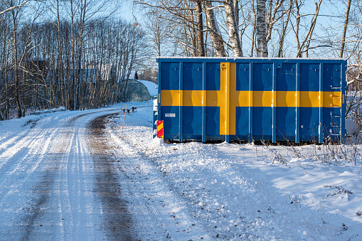 Big metal container painted with the Swedish flag Kumla Sweden November 29 2023