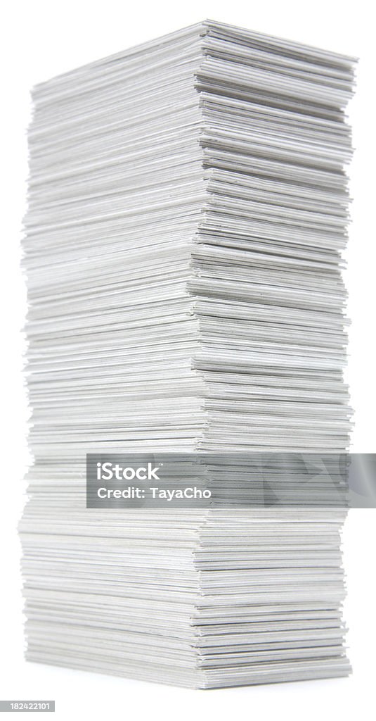 Stack of hand trimmed cards on white Untidy towering pile of index cards isolated on a white background. Bureaucracy Stock Photo