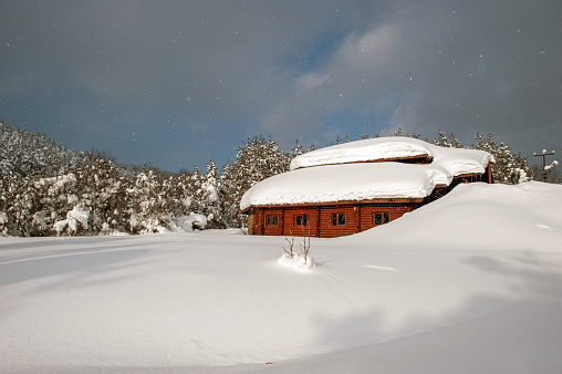 Wooden mountain hut buried under snow in Abant