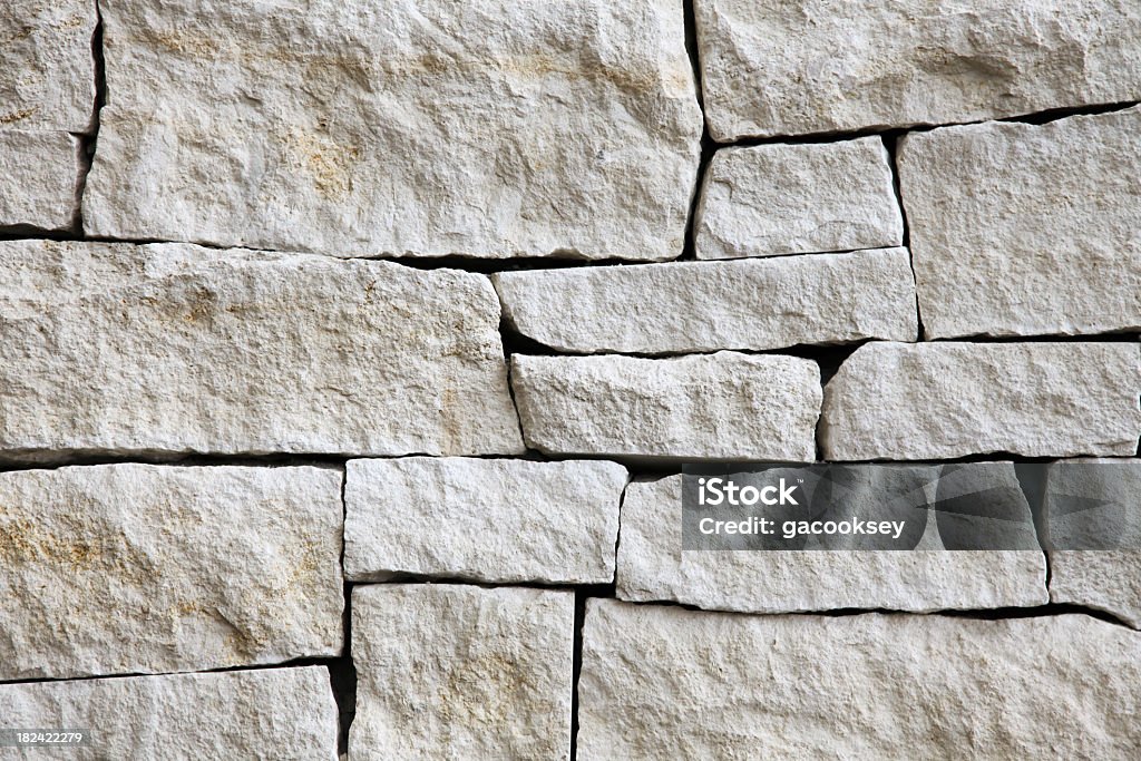 Stacked limestone blocks exquisite pattern of stacked limestone blocks on interior wall. Quarried from Kansas, USA. Stone Wall Stock Photo
