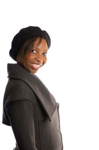 Side view of smiling African American Woman in beret and coat.