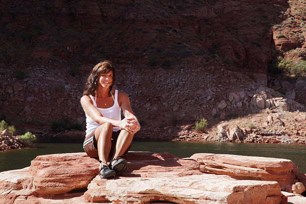 istock Woman Rests From Exercise Atop Red Rocks 182422582