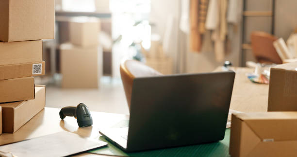 istock Empty office in small business, boxes or laptop for e commerce, startup or inventory in shop. Background, delivery checklist or technology for courier logistics, cargo stock or online package order 1824226139