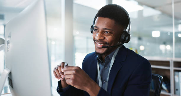istock Computer, call center and happy black man talking, crm and technical support at help desk. Communication, customer service and sales agent consulting, telemarketing advisory and speaking to contact 1824229921