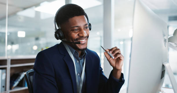 istock Computer, call center and black man talking, telemarketing and technical support at help desk. Communication, customer service and happy sales agent consulting, crm advisory and speaking to contact 1824229923
