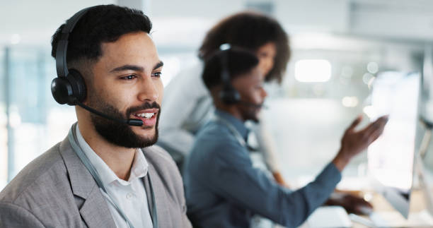 istock Computer, call center and happy man talking, crm and support at help desk office. Technology, customer service and sales agent consulting, telemarketing communication or speaking to business contact 1824231000