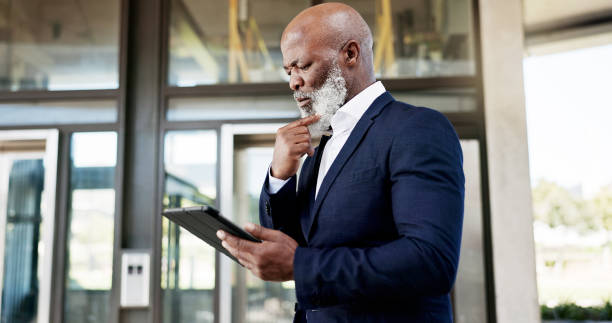 istock Outdoor, business and senior man with a tablet, thinking and confused with data analysis, research and email notification. African person, employee and accountant with technology, outside and doubt 1824232602