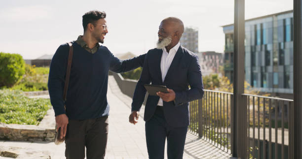 istock Walking, outdoor and business people with tablet, support and connection with planning, teamwork and partnership. Staff, manager and employee outside, tech and cooperation with digital app or talking 1824232623