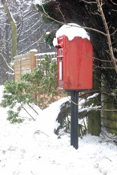 istock Postbox in snowy country lane 182423298
