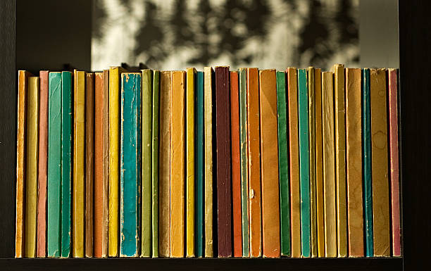 row of colorful old books stock photo