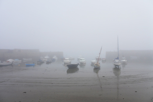 The harbour at St. Michael's Mount, Cornwall shrouded in mist at low tide