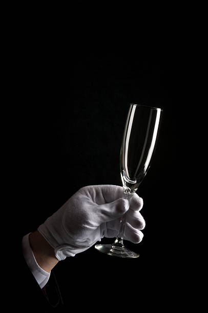 istock Gloved Hand holding Champagne Glass 182423601