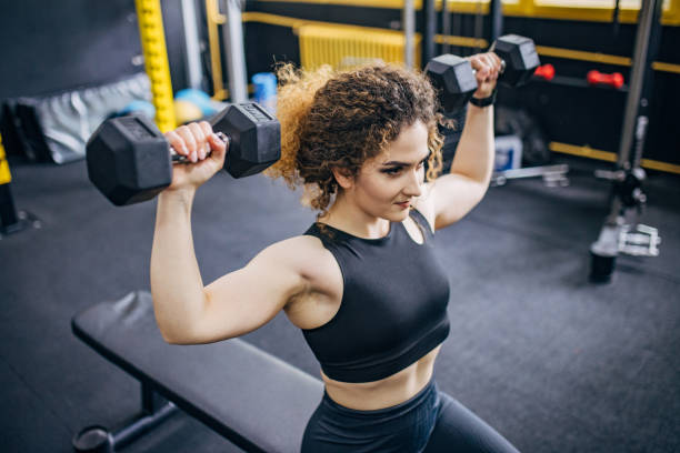 istock Fit woman training with dumbbells 1824250279