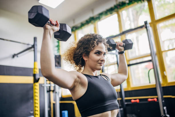 istock Fit woman training with dumbbells 1824250785