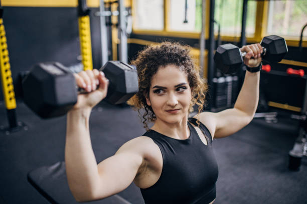 istock Fit woman training with dumbbells 1824250792
