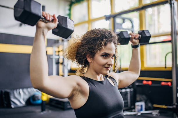 istock Fit woman training with dumbbells 1824250804