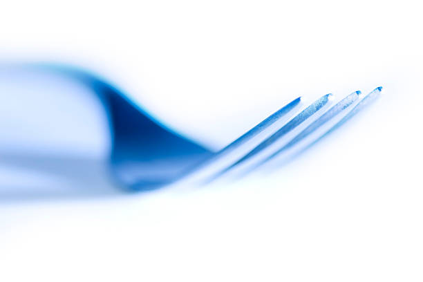 Fork Lit with Blue on White Background stock photo