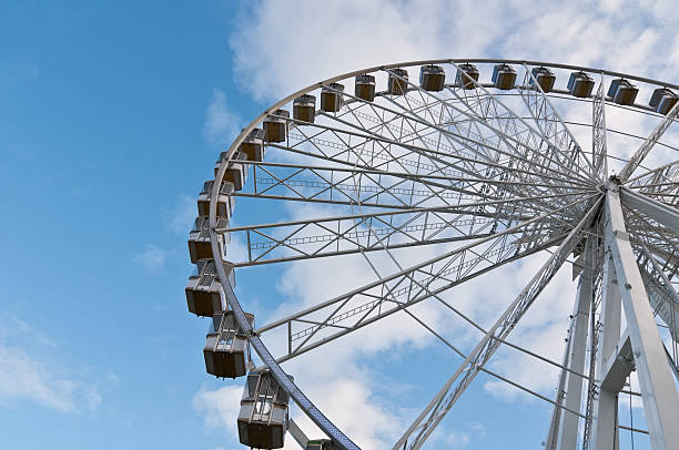istock Ferris wheel against blue sky 182425936