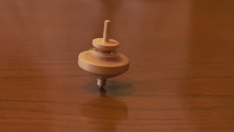 View of spinning wooden top on wooden table