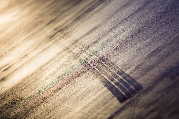 Car Skid Mark Abstract Abstract texture shot of a skid mark from a car on a reflective concrete surface street skid marks stock pictures, royalty-free photos & images